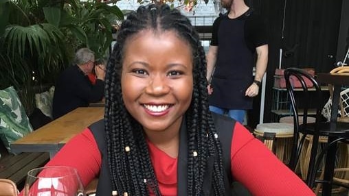 Santilla Chingaipe at dinner table for story about her braided hair