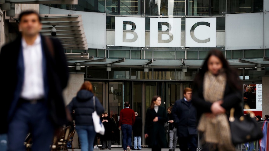 Pedestrians walk past a BBC logo at Broadcasting House in London, Britain January 29, 2020. REUTERS/Henry Nicholls/File Photo