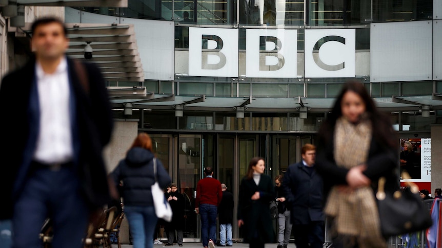 Pedestrians walk past a BBC logo at Broadcasting House in London, Britain January 29, 2020. 