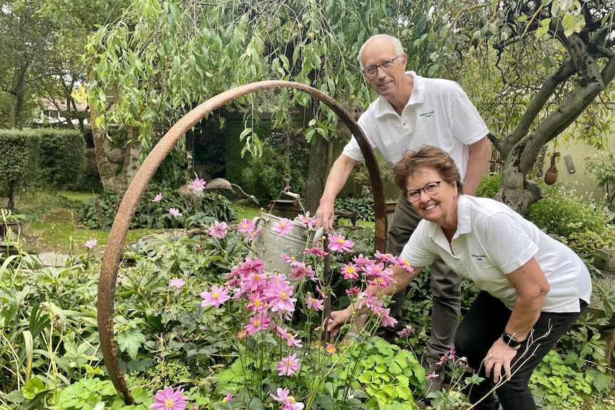 A smiling man and woman in a garden