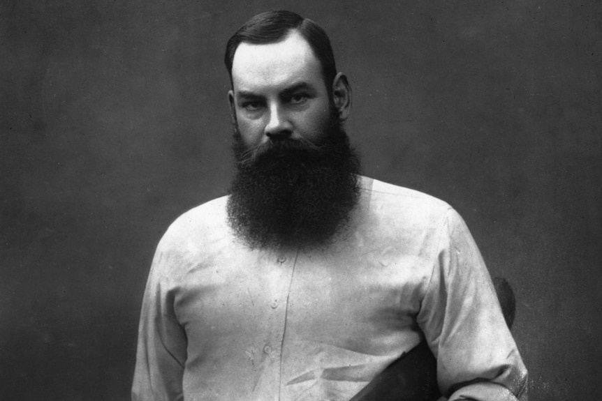 WG Grace poses with a bat under his arm