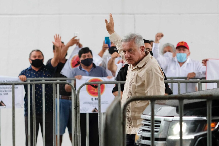 Mexican President Andres Manuel Lopez Obrador waves to supporters.