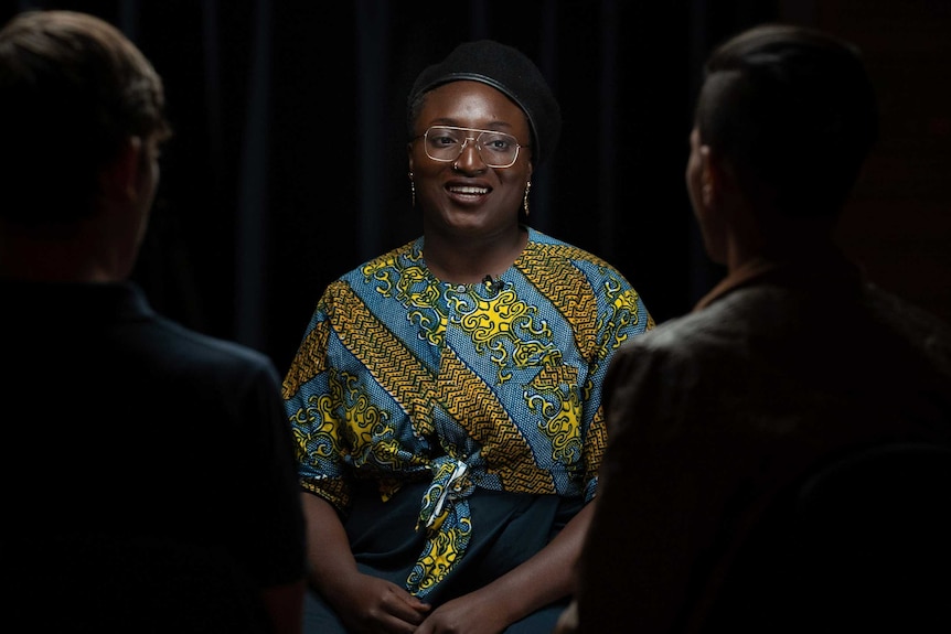 Ayebatonye Abrakasa smiling in a group.