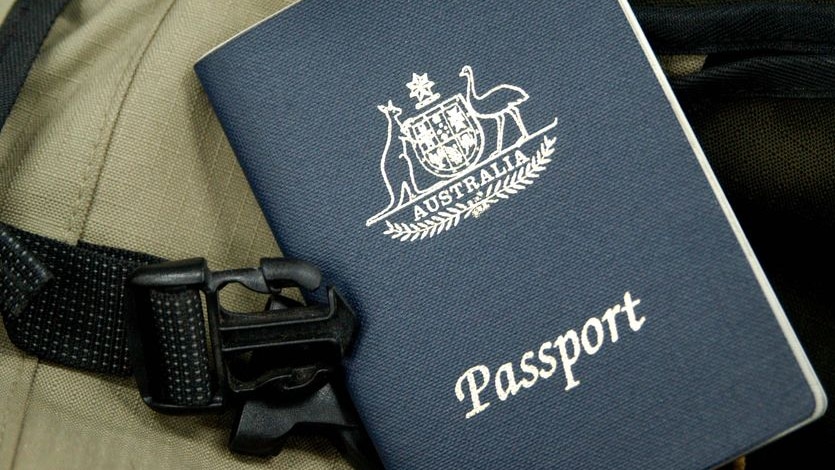 An Australian passport sits on a backpack