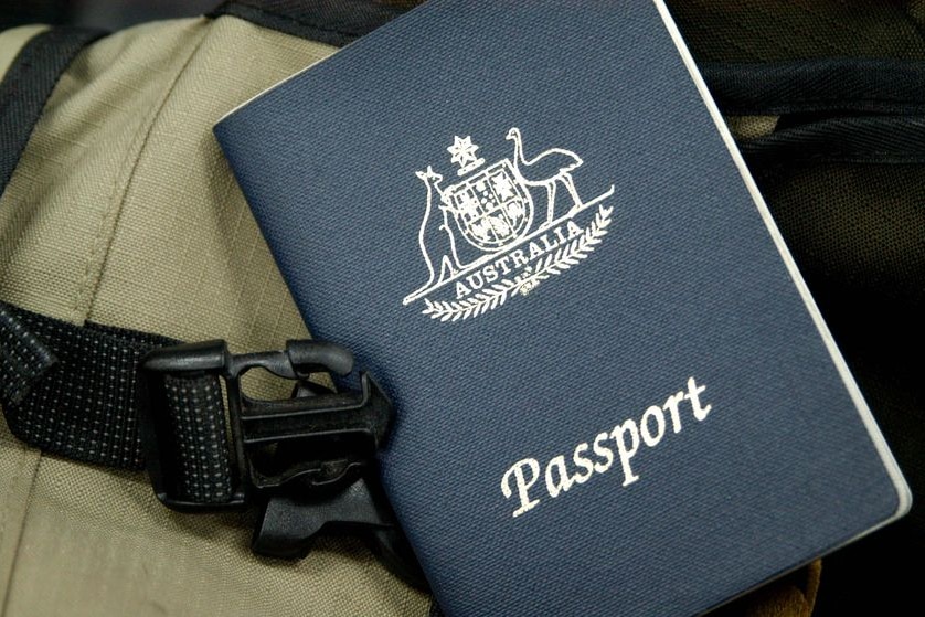 An Australian passport sits on a backpack