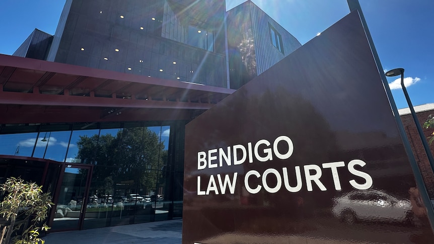 A sign that reads "Bendigo Law Courts" in front of a modern-looking building on a sunny day.