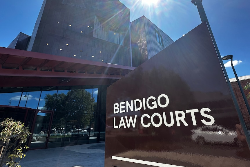 A sign that reads "Bendigo Law Courts" in front of a modern-looking building on a sunny day.
