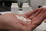 Handful of aspirin pills.