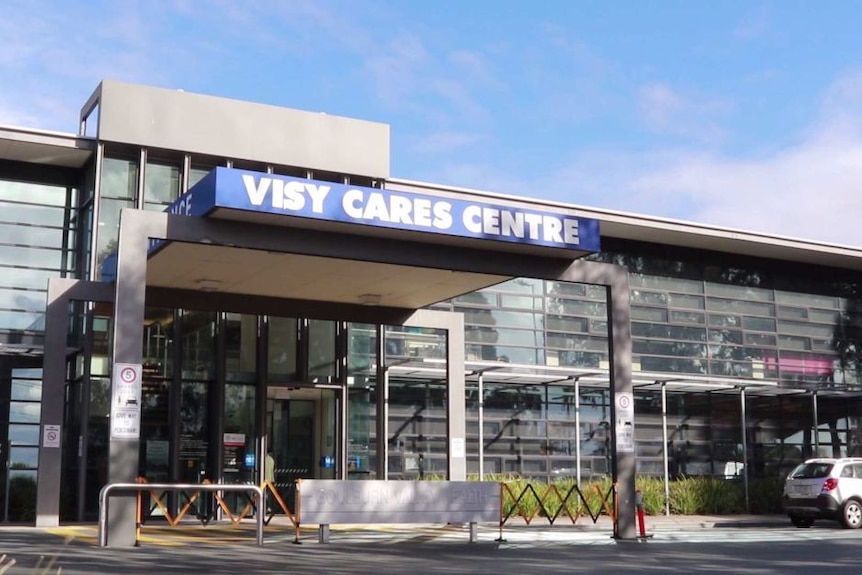 An exterior shot of a hospital building, signposted VISY CARES CENTRE.