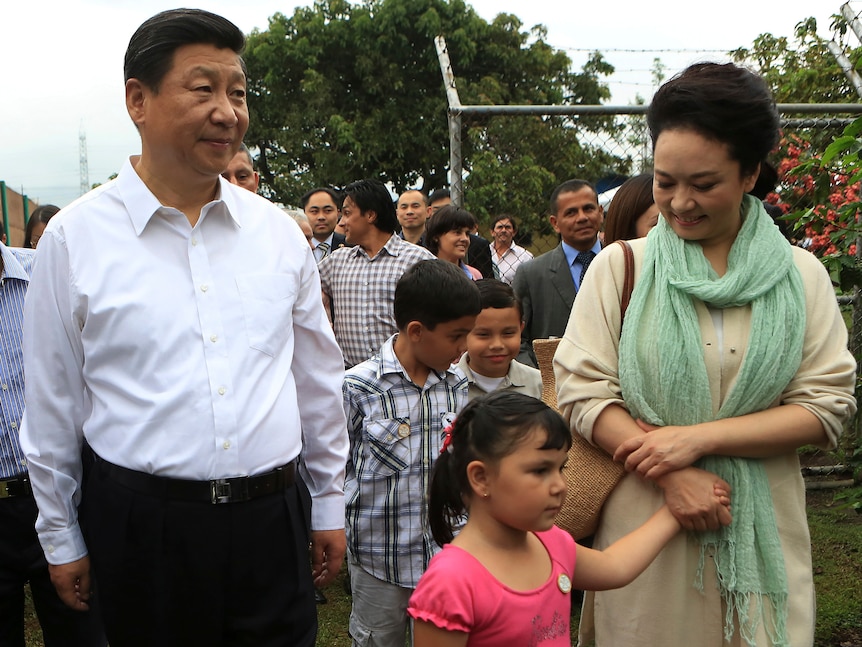 China's President Xi Jinping and his wife Peng Liyuan walk next to children