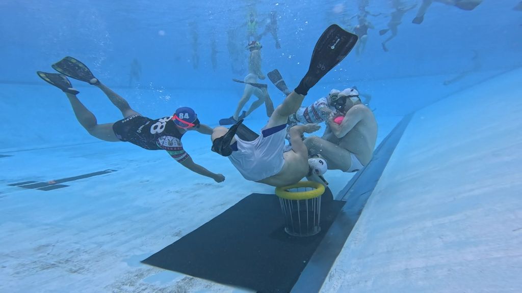 Underwater rugby players battle it out at the bottom of the pool