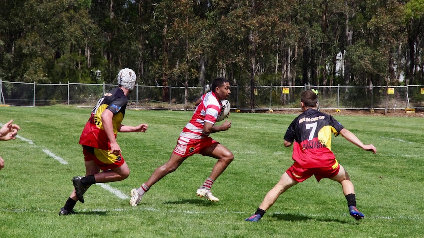 distant action short of men playing rugby league