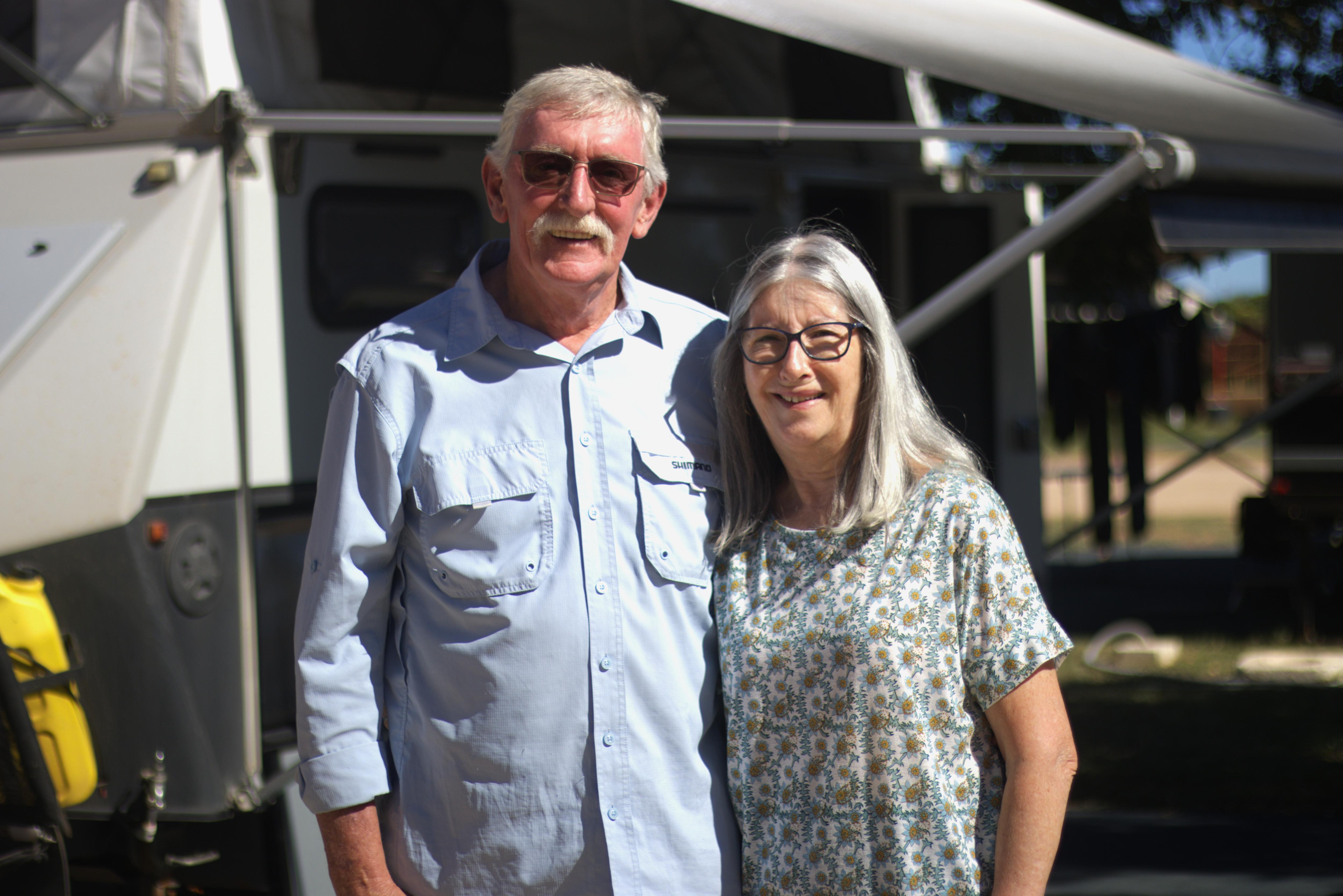 Stephen and Margaret Gilham standing in front of their trailer