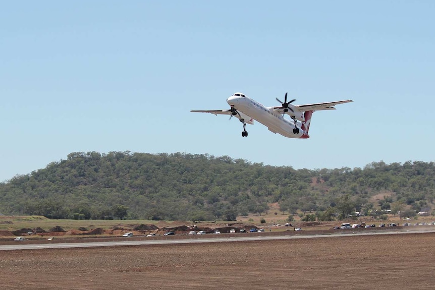 A QantasLink plane in the air.