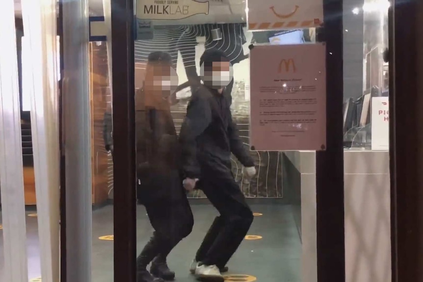 Vloggers dancing in Macca's in Melbourne's CBD as they wait for their meal.