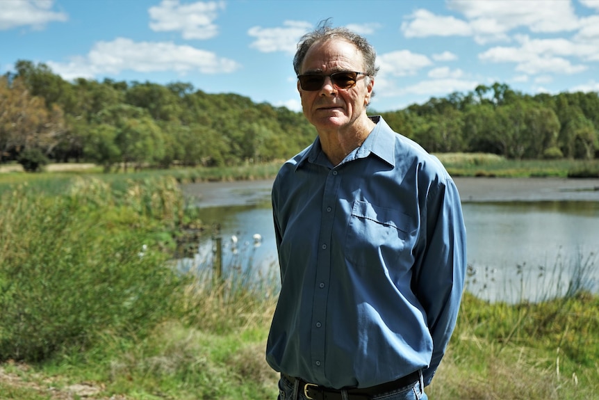 Man stands in front of Perry Lake