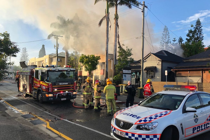 Firefighters and police outside a unit fire in South Brisbane.