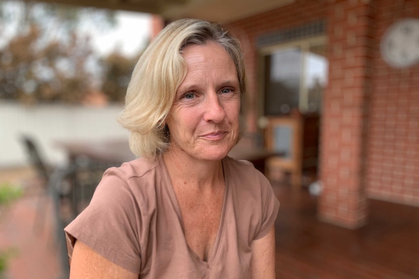 Woman sitting looks at camera