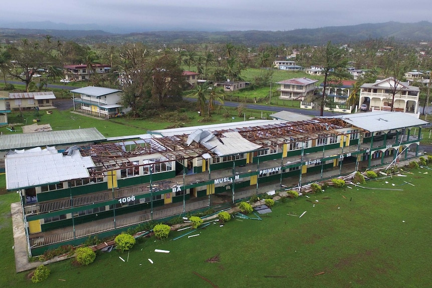 Aerial photo showing the roof missing off a primary school building housing several classrooms.