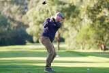 A male golfer takes a swing on a fairway at Brighton Golf Course in Melbourne.