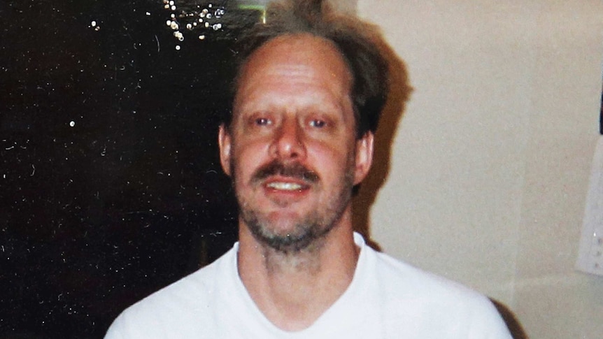 A man in a t-shirt smiles at the camera.