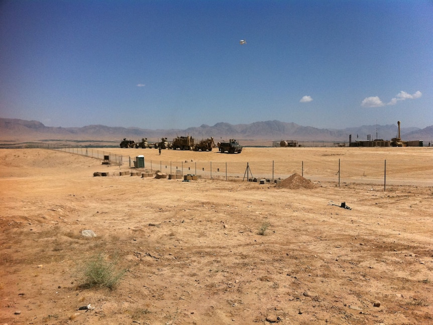 The Tarin Kot military base sits in a bowl of rolling plains surrounded by sharply ridged mountains.