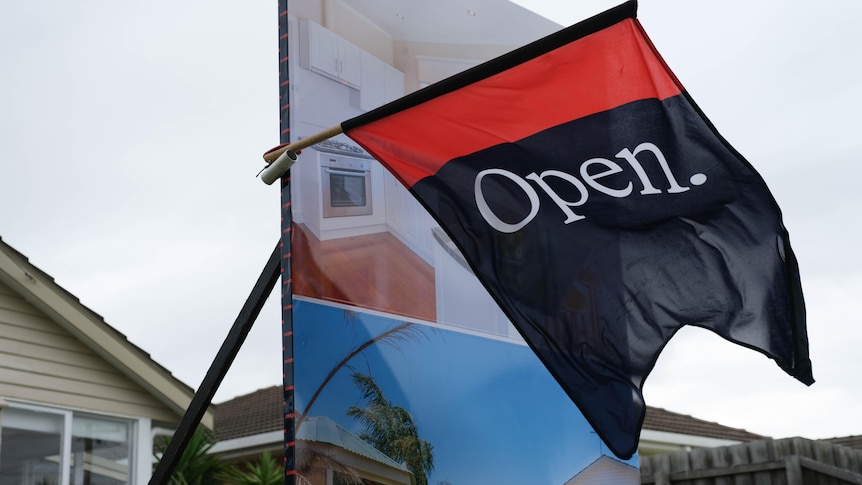 An open home flag flaps in the wind.  