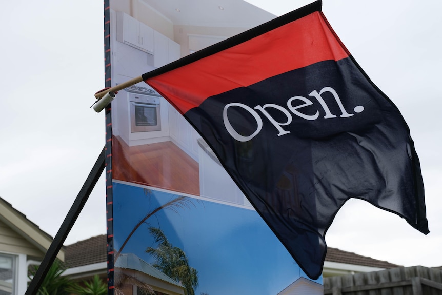 An open home flag flaps in the wind.  