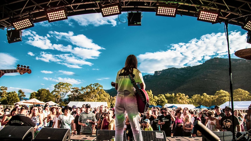 Performer Angie Mcmahon on stage playing for crowds at a previous Grampians Music Festival