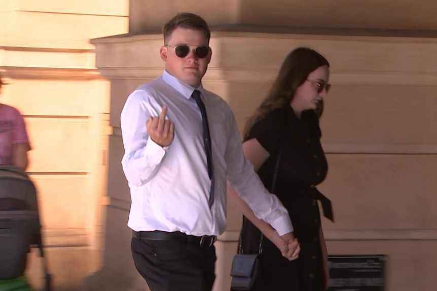 Cameron Brodie-Halls puts up his middle finger outside court.