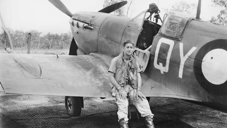 Flight Sergeant Colin Duncan sits in front of his plane, which crashed at Litchfield National Park in 1943.