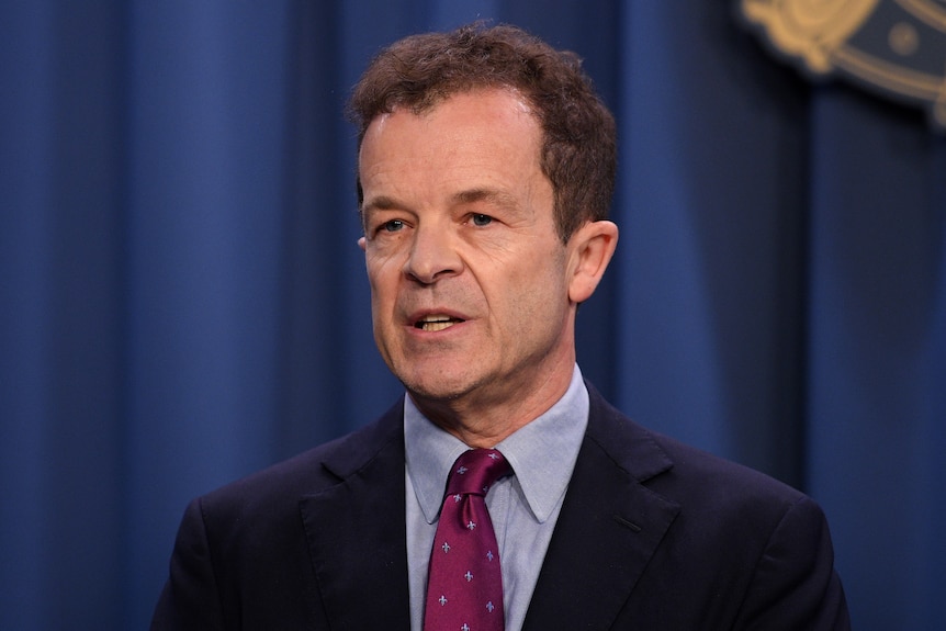 a man talking behind a lectern