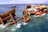 Stricken container ship Rena slips off a reef in the Bay of Plenty