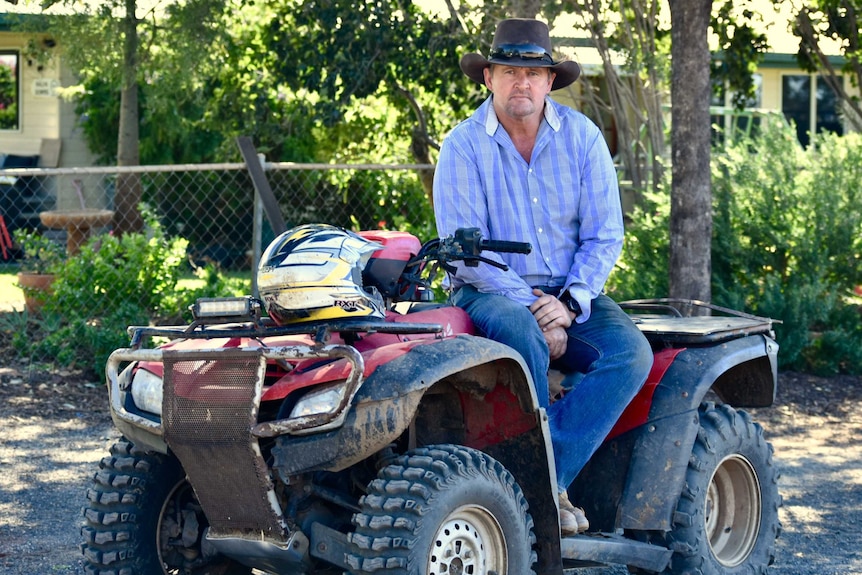 A man sits on a quad bike
