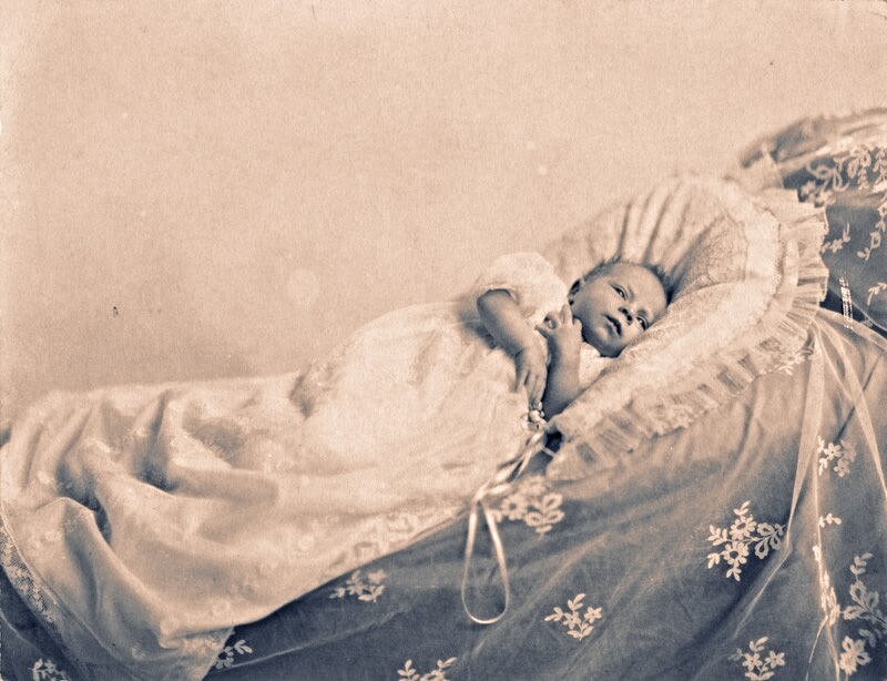 A black and white photo shows Queen Elizabeth II as a baby.