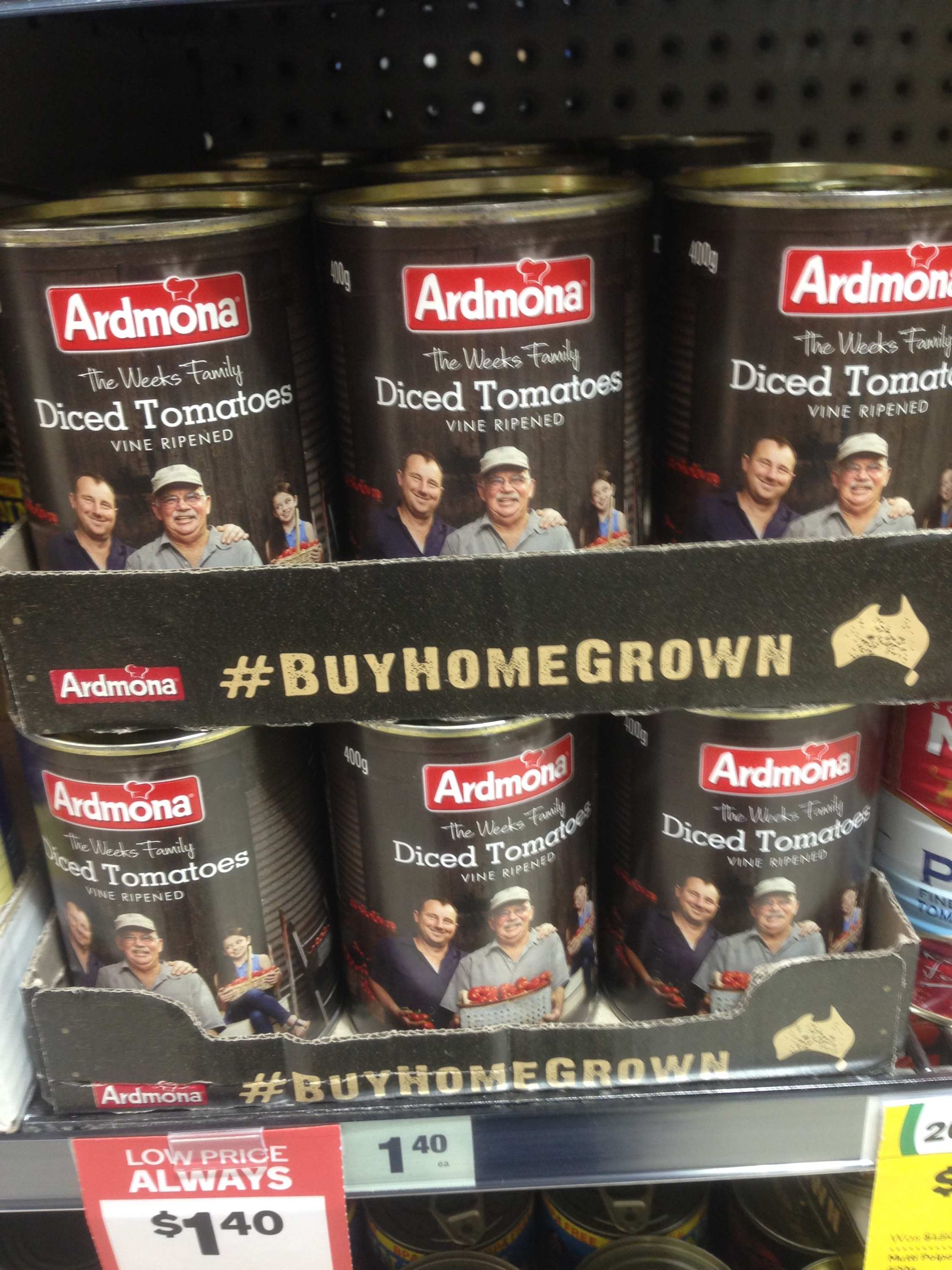 cans of tomatoes on a supermarket shelf