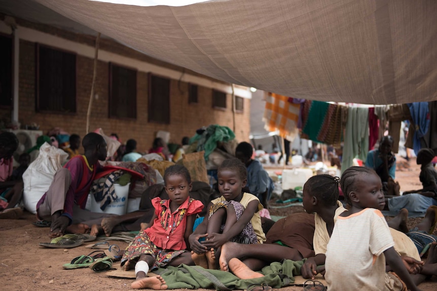 Children displaced by fighting wait to be registered at a camp in Wau, South Sudan
