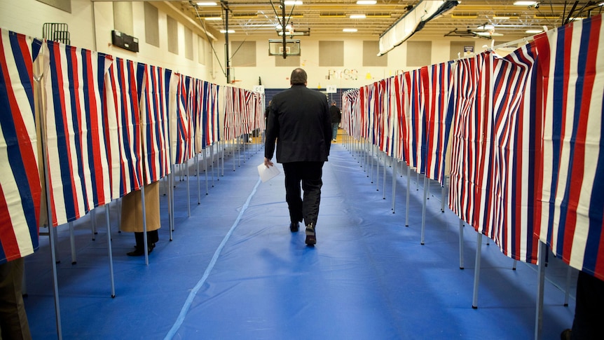 A man votes in the New Hampshire primary at Bedford High School on January 10, 2012