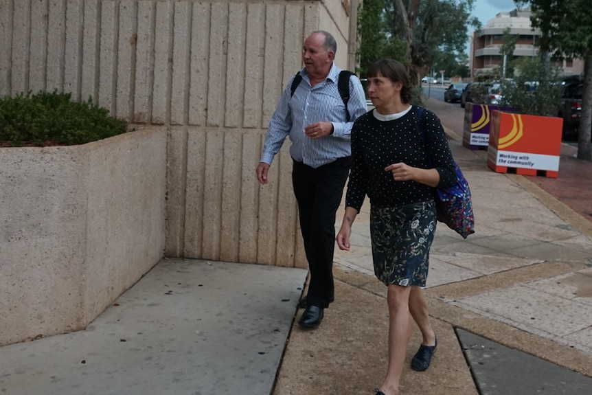 A man leaves the Alice Springs Local court with his lawyer. 