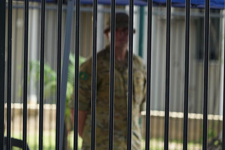 An ADF soldier, wearing uniform, stands outside the Travelodge in Darwin.