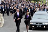 Mourners follow hearse