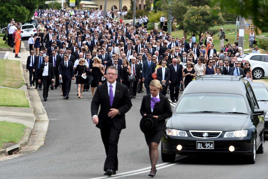 Mourners follow hearse