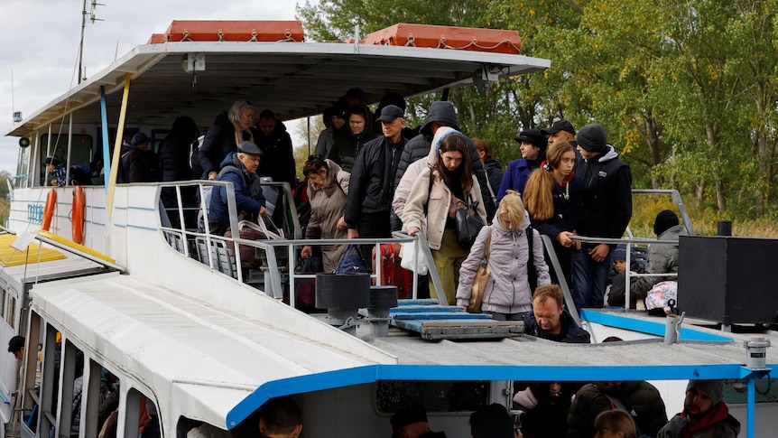 Civilians evacuated from Kherson travel by ferry.