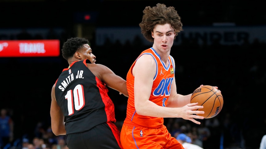 Oklahoma City Thunder guard Josh Giddey spins around Portland Trail Blazers guard Dennis Smith Jr