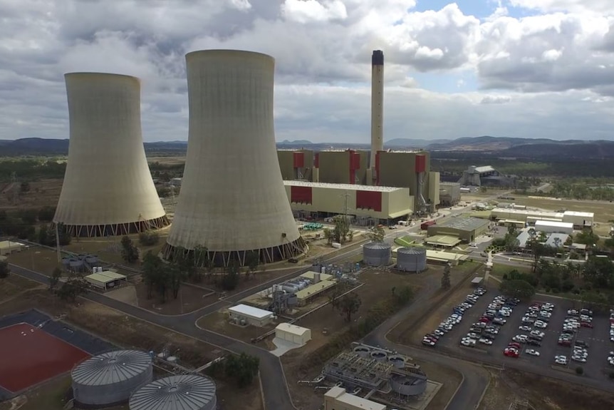 Aerial shot of the Stanwell power station, with cooling and smoke stacks and car park.