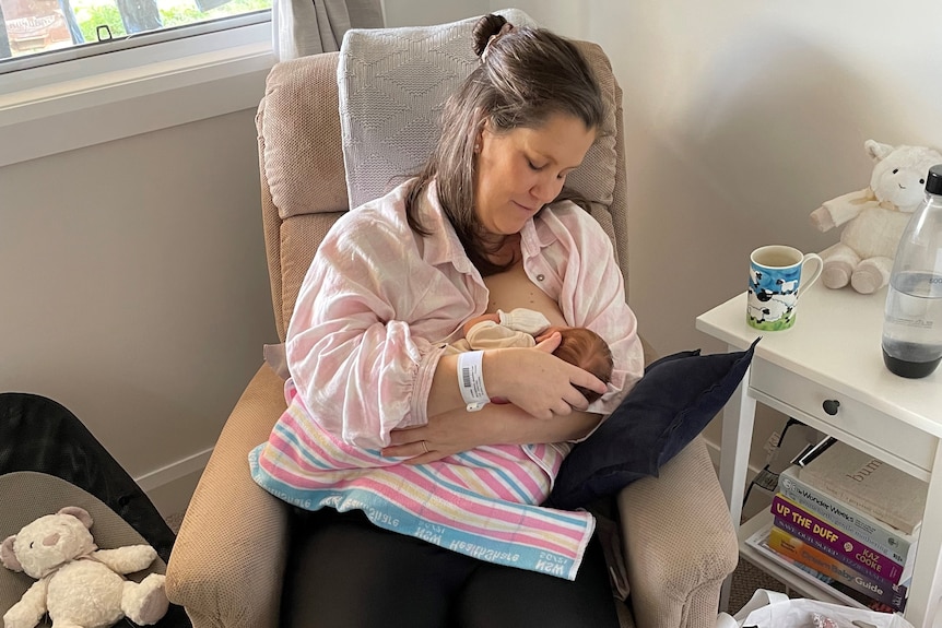 mum in pink shirt breastfeeding baby