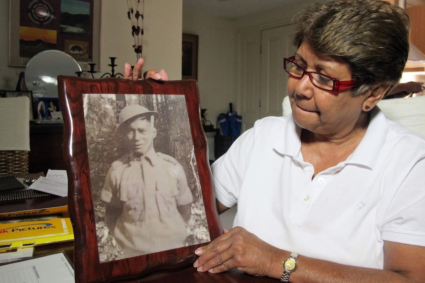 Linda Boney proudly holds a photo of her father Gunner Percy Suey