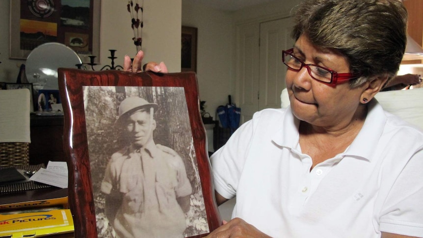 Linda Boney proudly holds a photo of her father Gunner Percy Suey