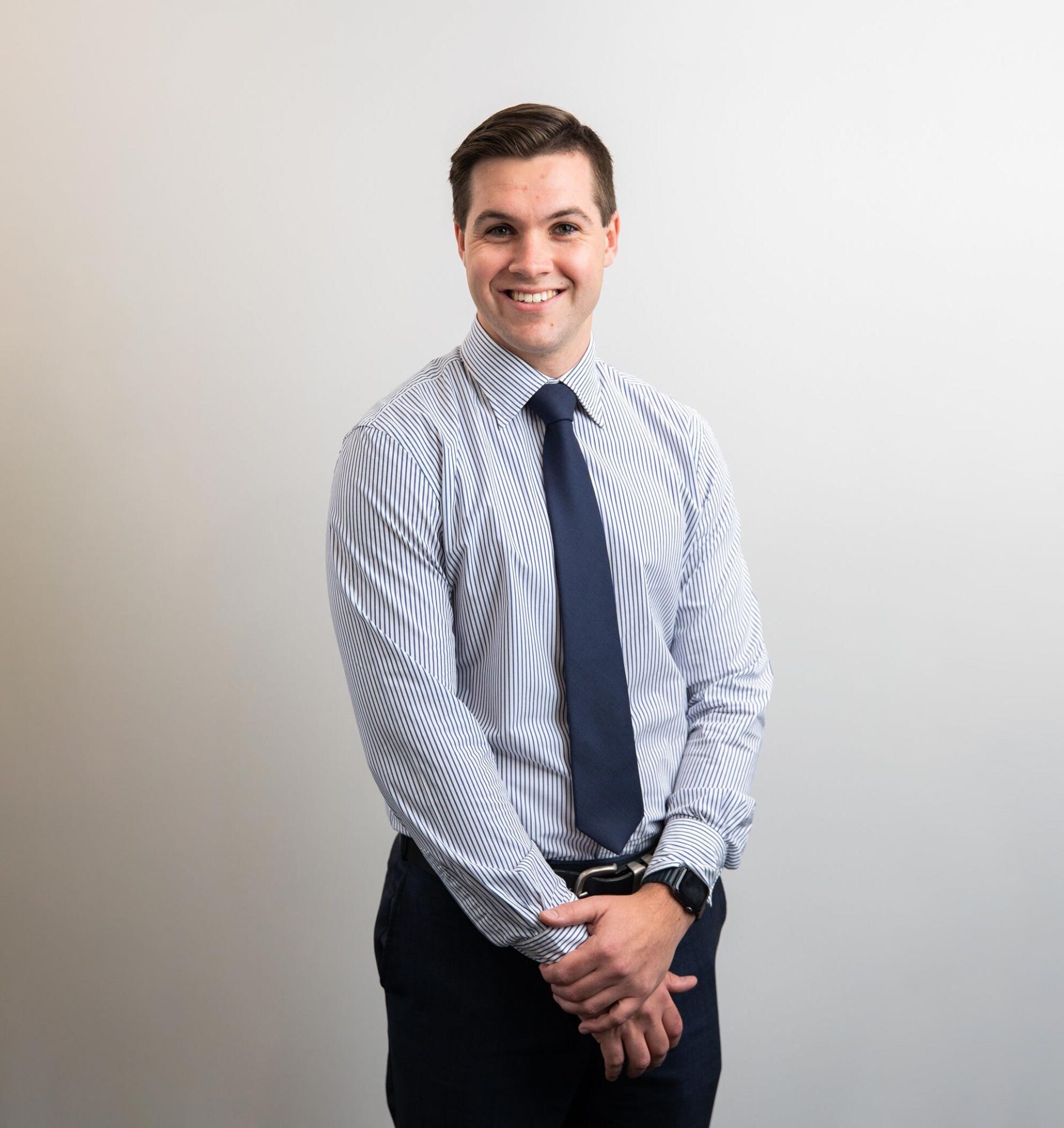 Man in suit shirt smiling at camera