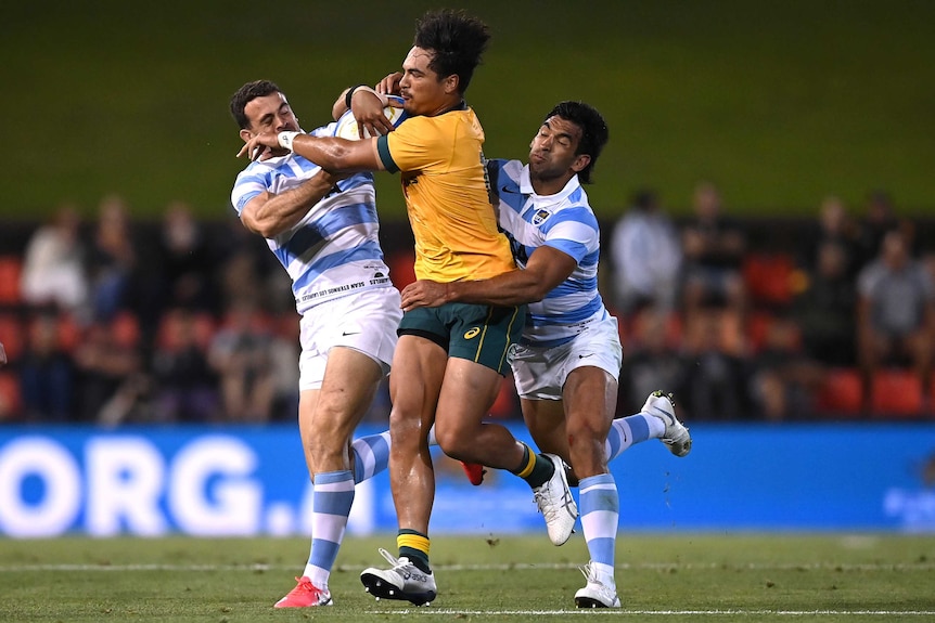 Wallabies' Jordan Petaia is tackled by Emiliano Boffelli (left) and Matias Orlando of Argentina Pumas.